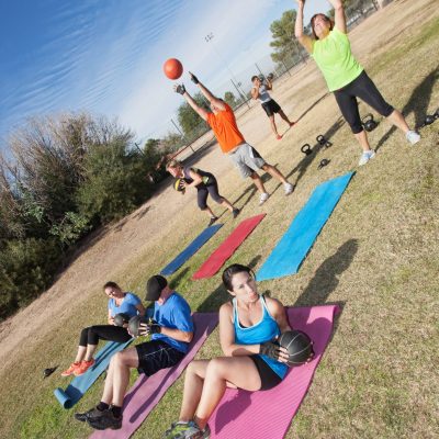 Diverse group of men and woman in boot camp fitness class